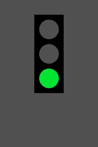 The same stoplight with the bottom lamp bright green and the upper two dark gray