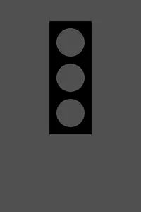 The stoplight with all three lamps a dull dark gray and none of them lit